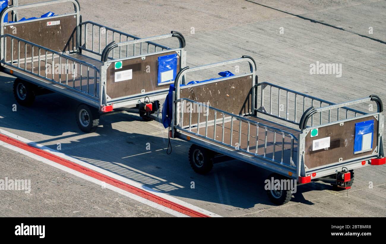 Image of empty luggage transportration cart in empty airport because of global economy crisis caused by coronavirus and COVD-19 pandemic Stock Photo