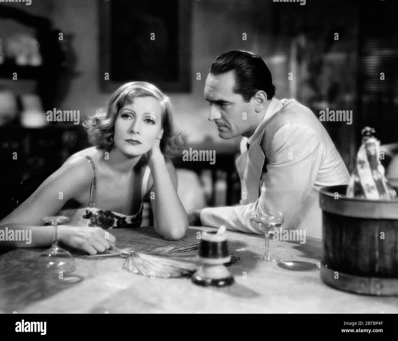 Swedish-born actress Greta Garbo (Retrospective), (born on September 18, 1905, died on April 15 ,1990 at aged 84) and John Miljan (1892 - 1960) as Burlingham in a scene from 'Susan Lenox (Her Fall and Rise)' (aka 'The Rise of Helga'), directed by Robert Z Leonard (1931) MGM /  File Reference # 34000-042THA Stock Photo