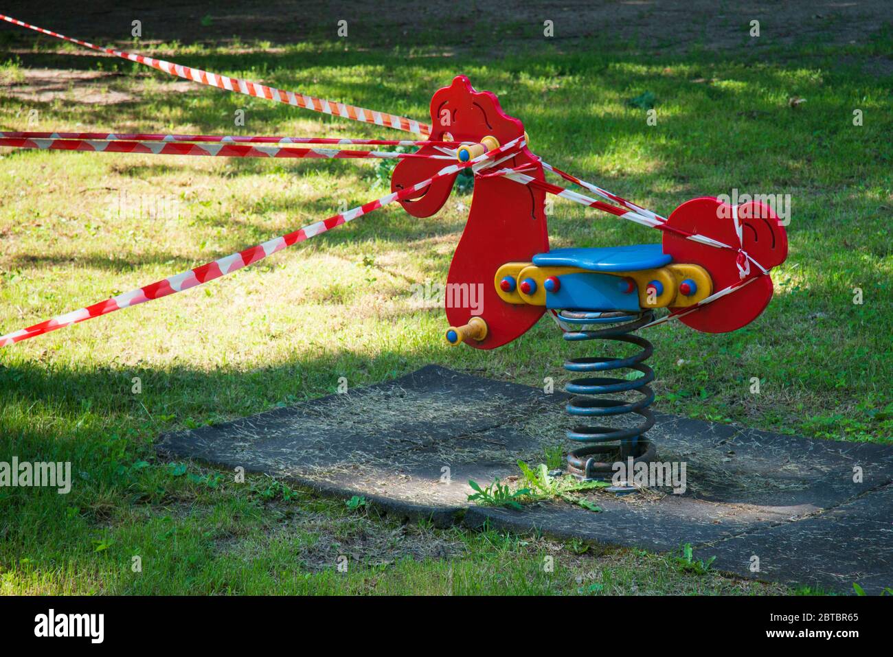 Italy, Lombardy, Crema, Park Children Playground  Closed due to the Covid-19 Virus with a Barrier Tape Stock Photo