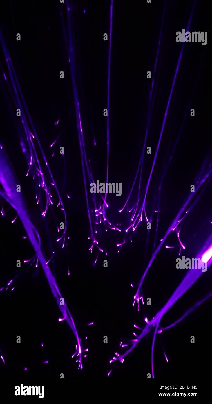 Overlaying wavy lines forming an abstract pattern on a dark background Stock Photo