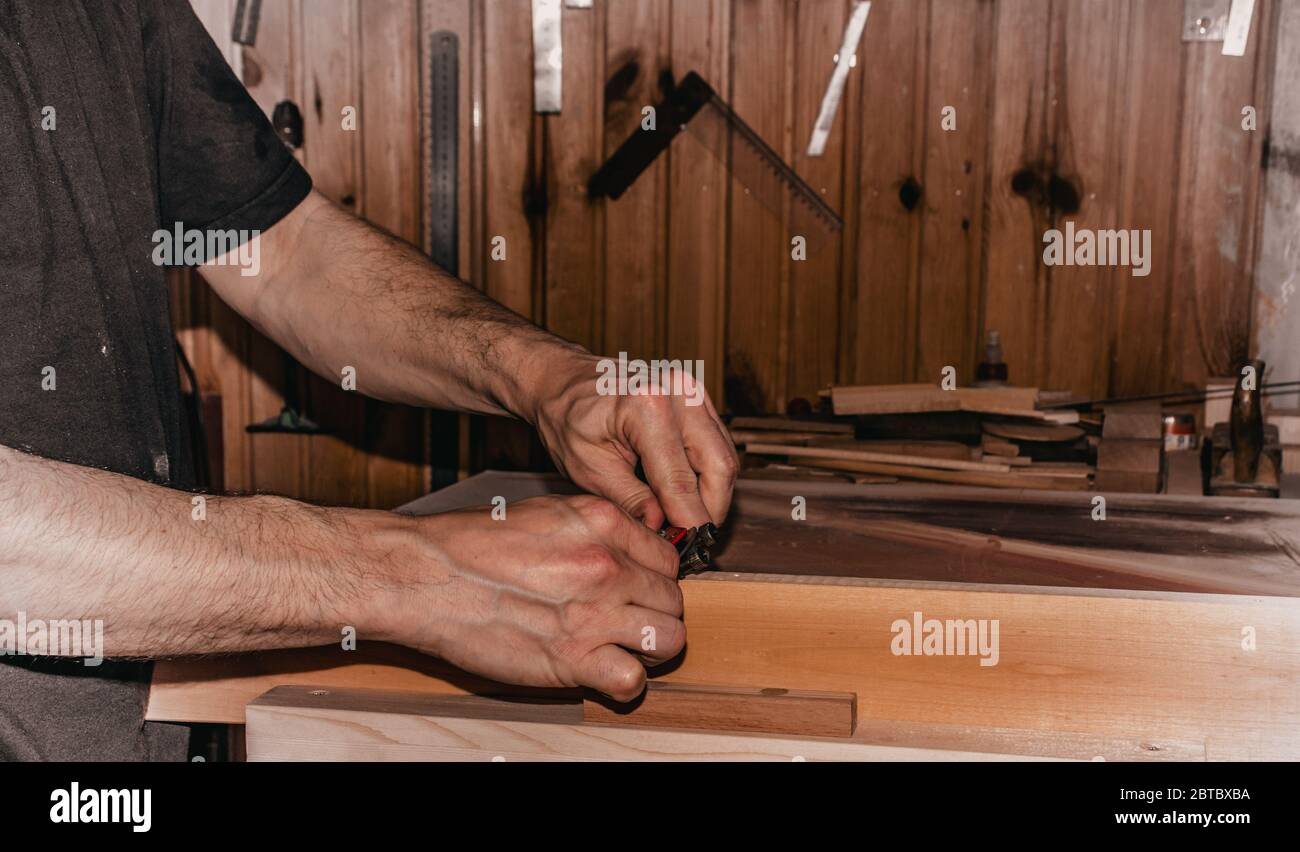 closeup scene of a male carpenter working in carpentry