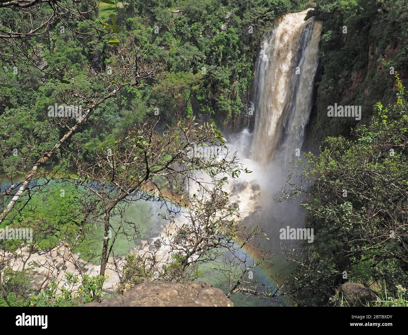 rainbow in the mist of thundering water vapour at Thomson's Falls where the Ewaso Ng'iro river tumbles 74m at Nyahururu, central Kenya, Africa Stock Photo