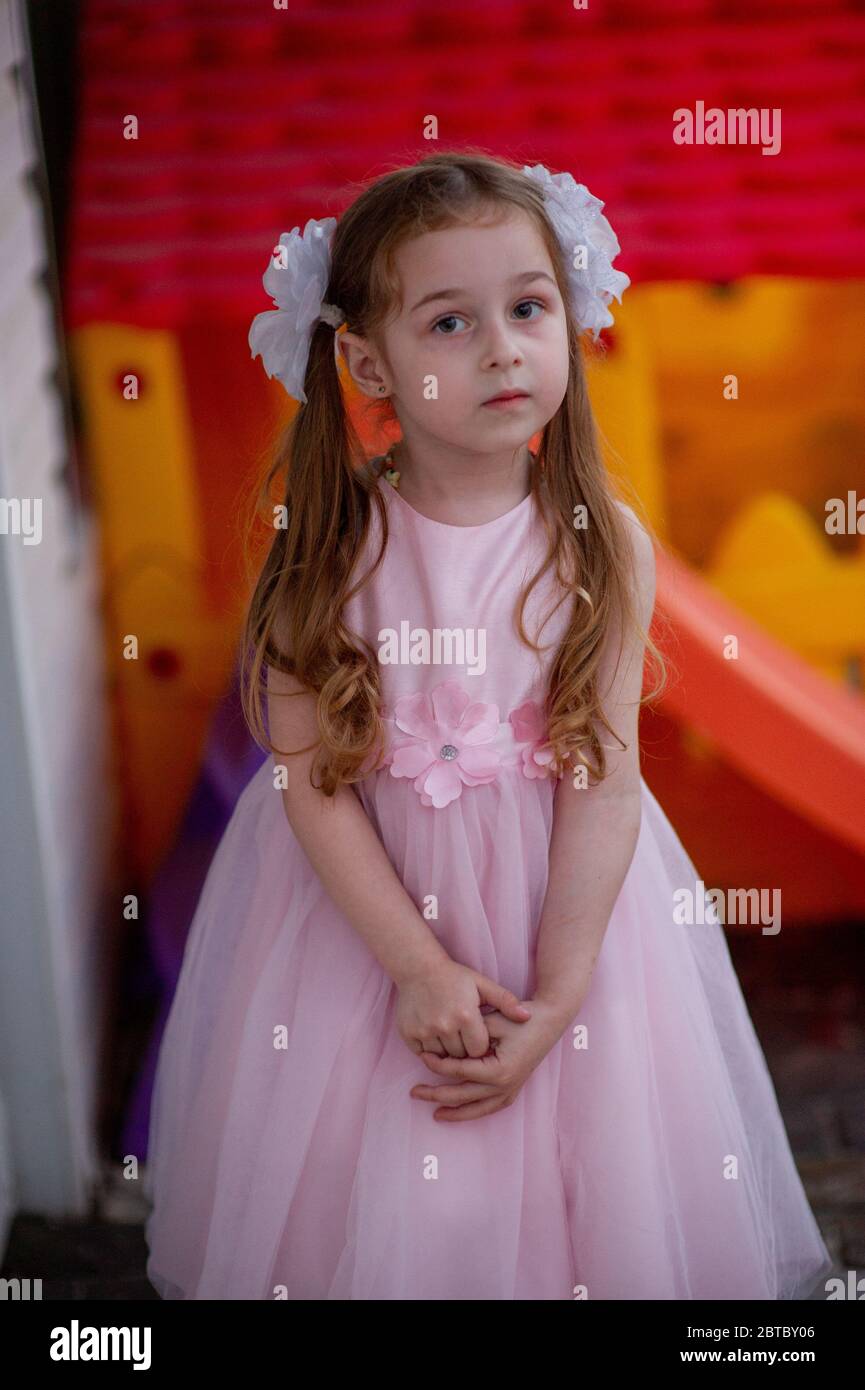 Cute five year old girl in a pink princess dress. portrait of a happy cute  blonde girl 5 years old. Little girl with two ponytails and white bows. Chi  Stock Photo - Alamy