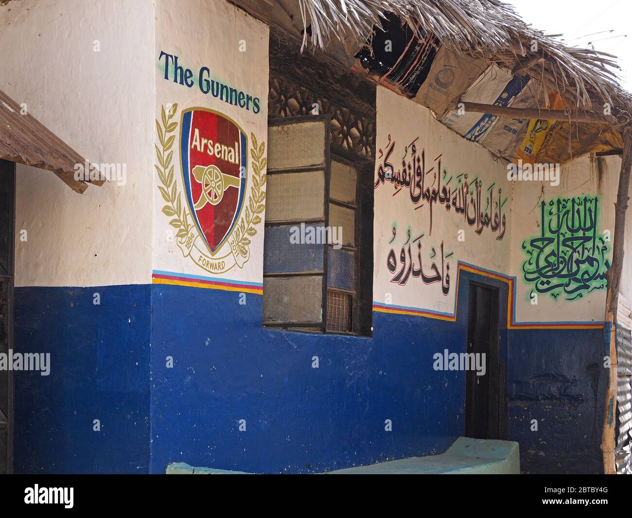 Arsenal crest and signage alongside Arabic script on painted walls of a small shop in the Old Town district of Malindi,on the Kenya coast, Africa Stock Photo