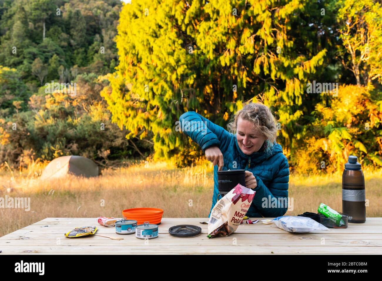 A camper preparing a meal, Tararua Ranges, New Zealand, February 2020 Stock Photo