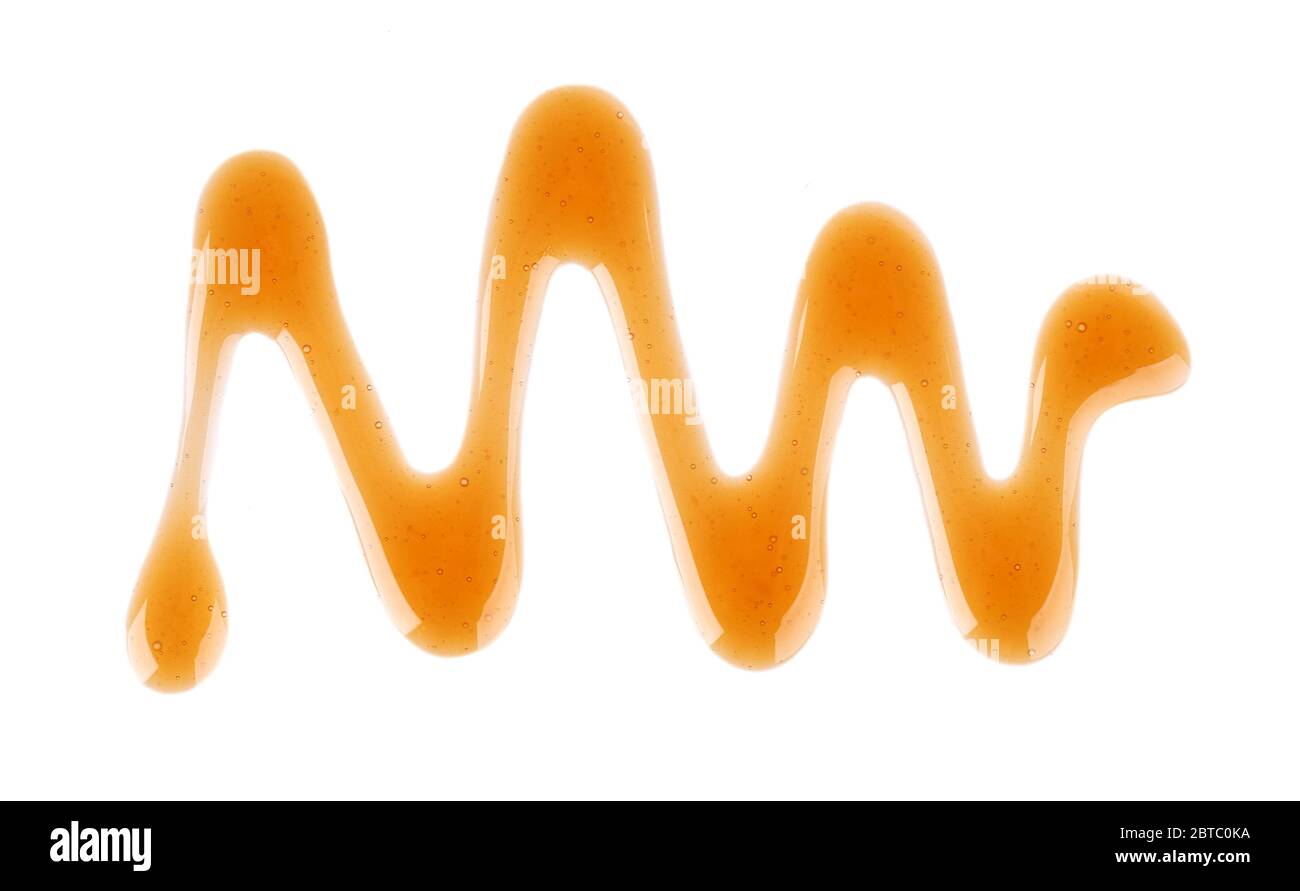 Caramel syrup drizzle isolated on white background. Splashes of sweet