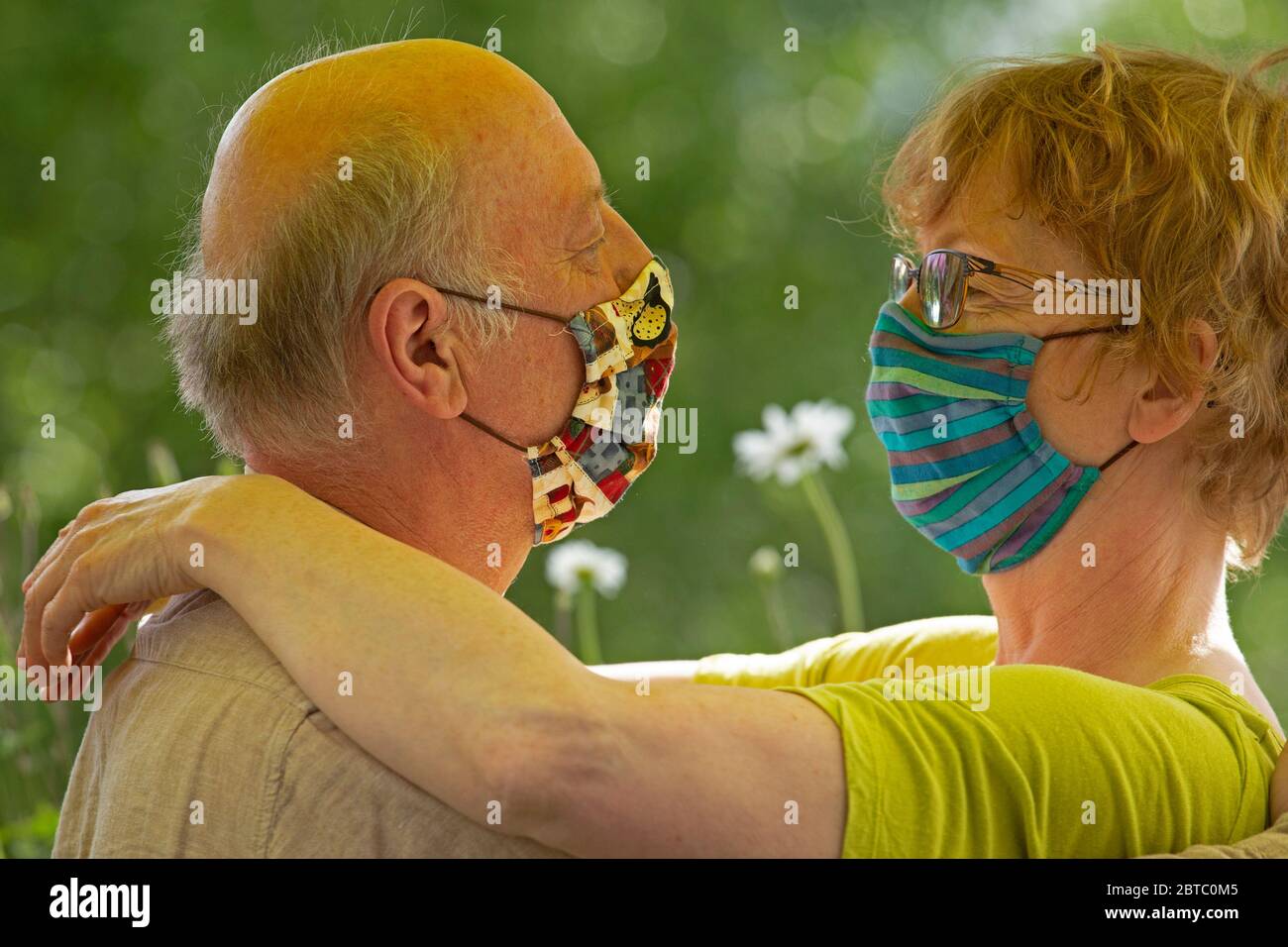 elderly couple wearing breathing masks, Germany Stock Photo