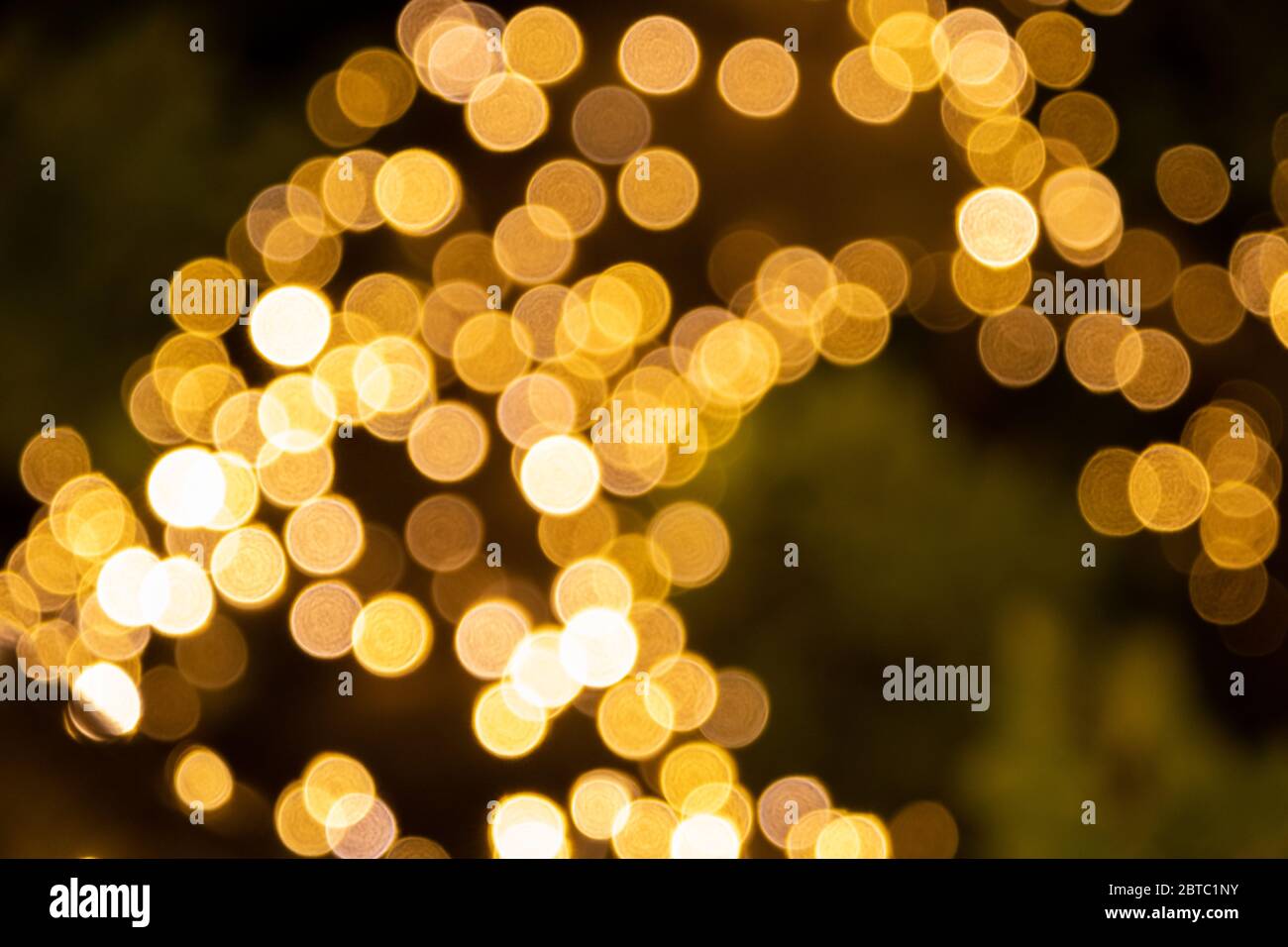 Background bokeh of sparkling golden party lights for festive or ...