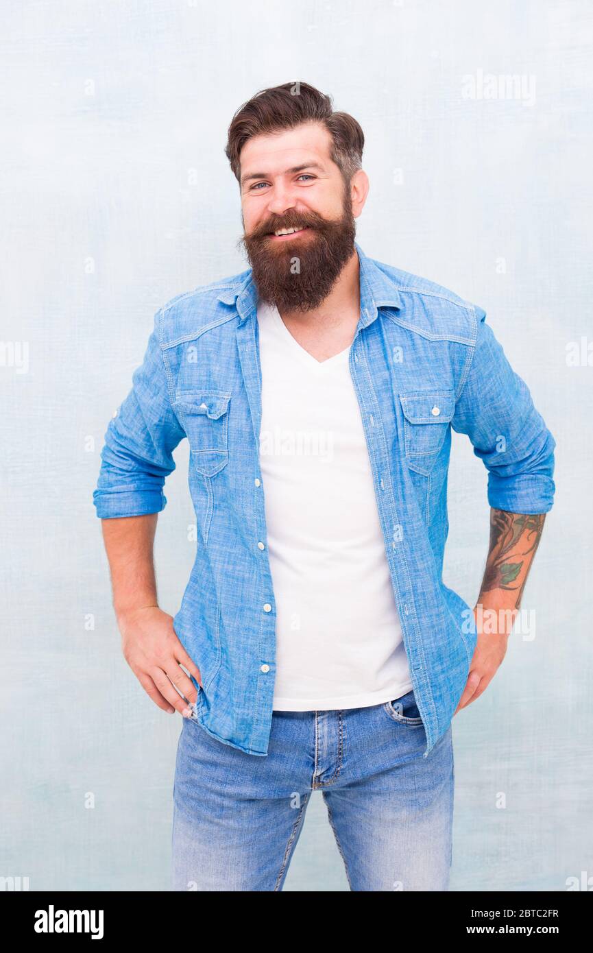 Good vibes. Charismatic barber with beard and mustache. Personality and Charisma concept. Bearded well groomed hipster. Good looking guy wear fashion clothes. Denim fashion trends. Barbershop fashion ...