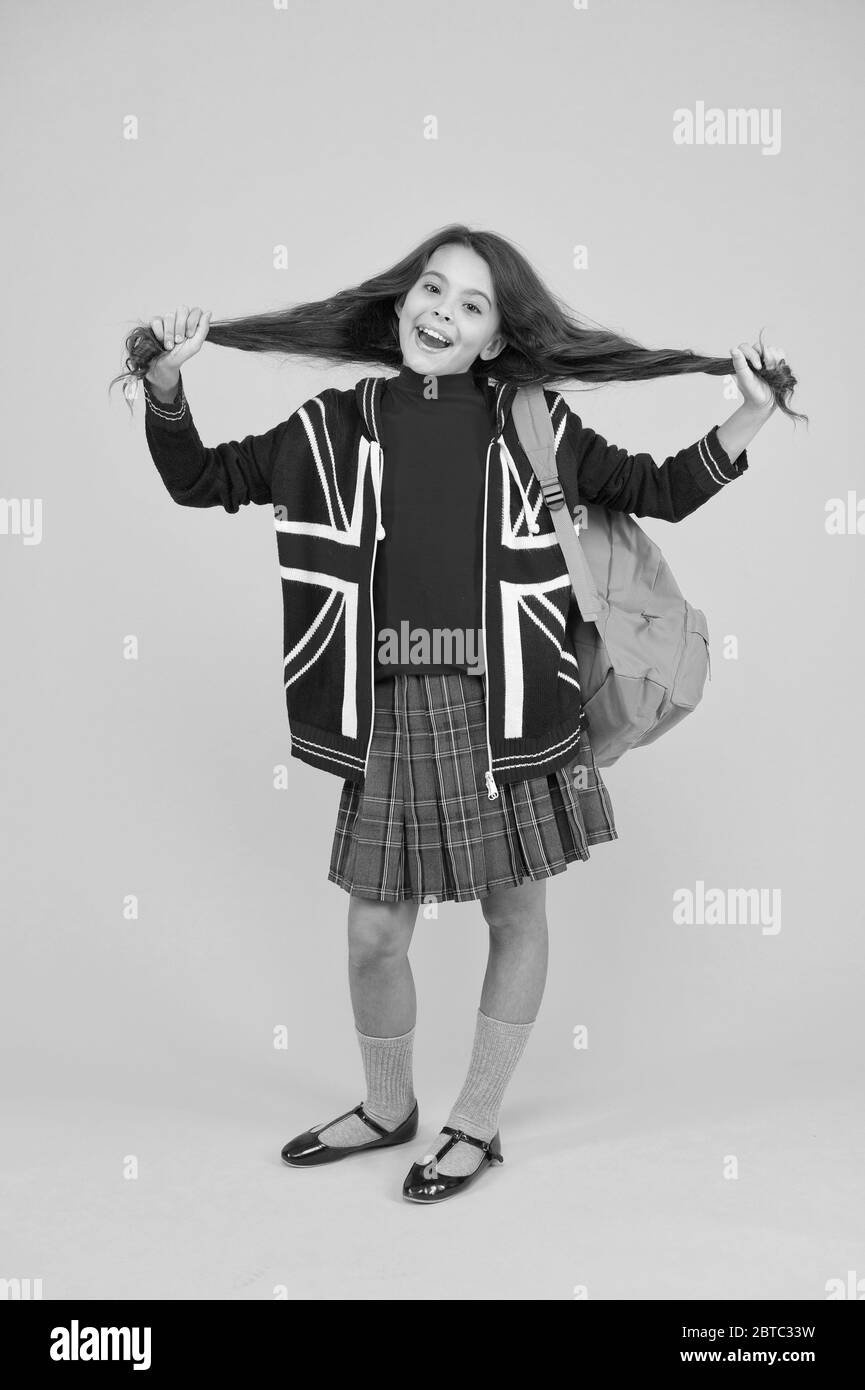 English kid backpack. British education program. Learn foreign language. Little girl wear school uniform. Primary, secondary and further education. Education in United Kingdom. English student. Stock Photo