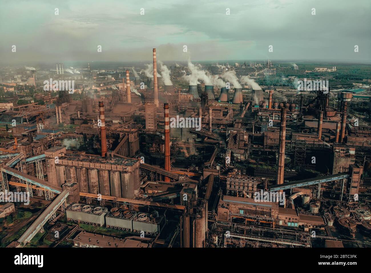 Air pollution by smoke from factory chimneys, aerial view. Industrial landscape from drone point of view. Stock Photo