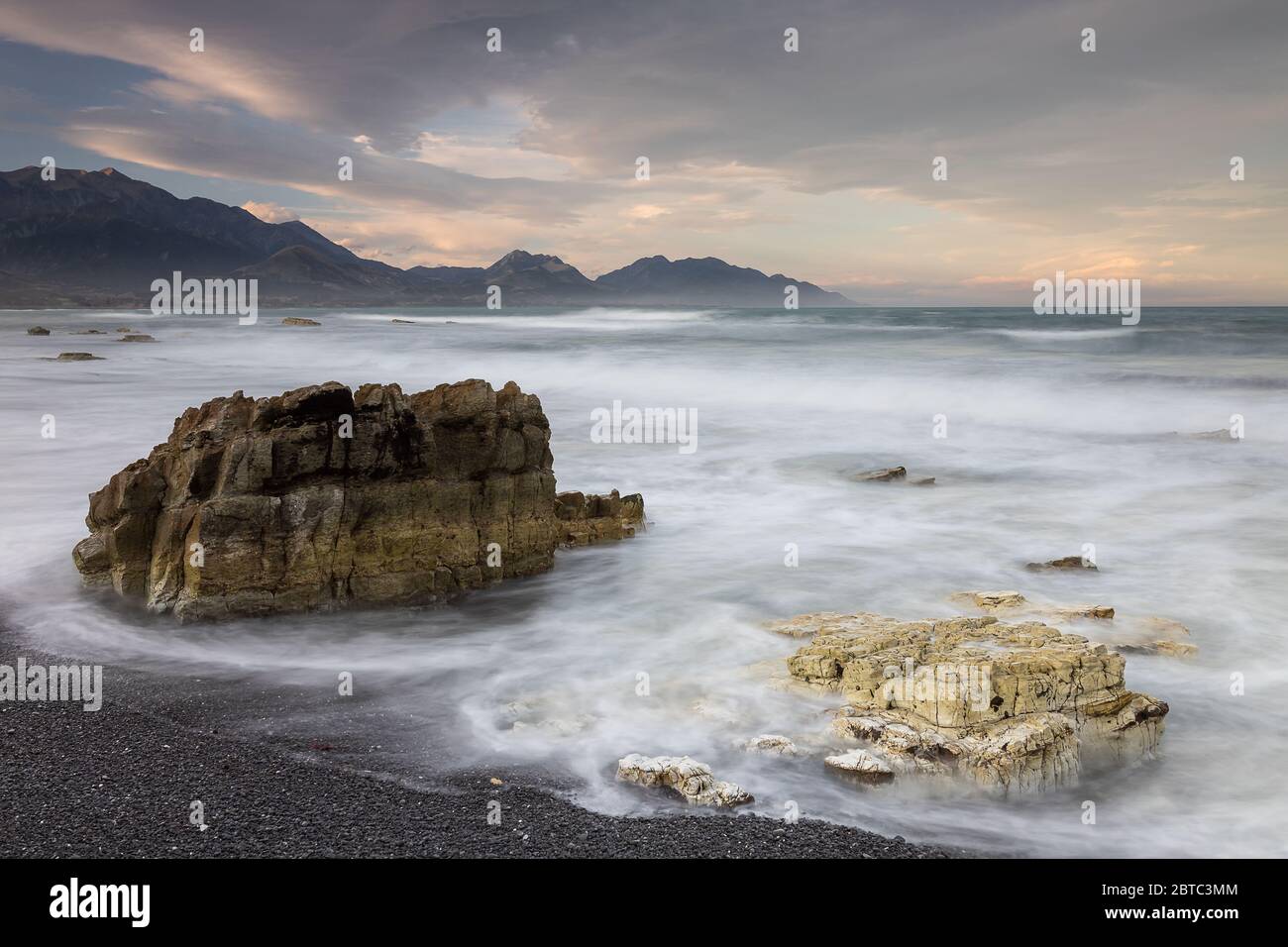 Rocks in breaking waves on Kaikoura coastline Stock Photo