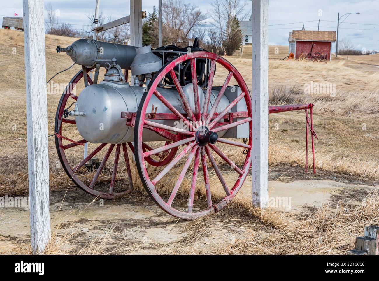 Antique fire fighting equipment on a wooden carriage in Admiral, Saskatchewan Stock Photo