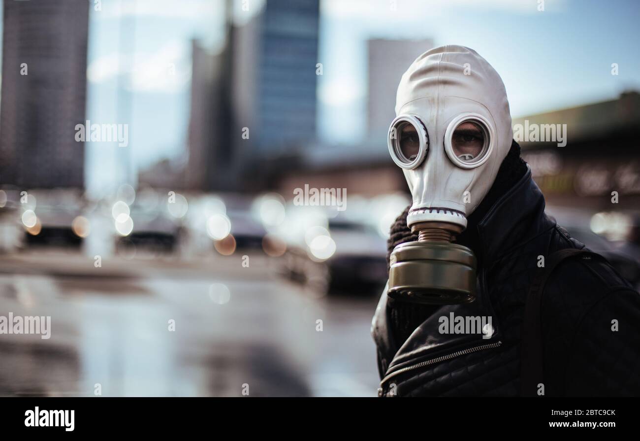 casual young man in a gas mask looking at the camera Stock Photo