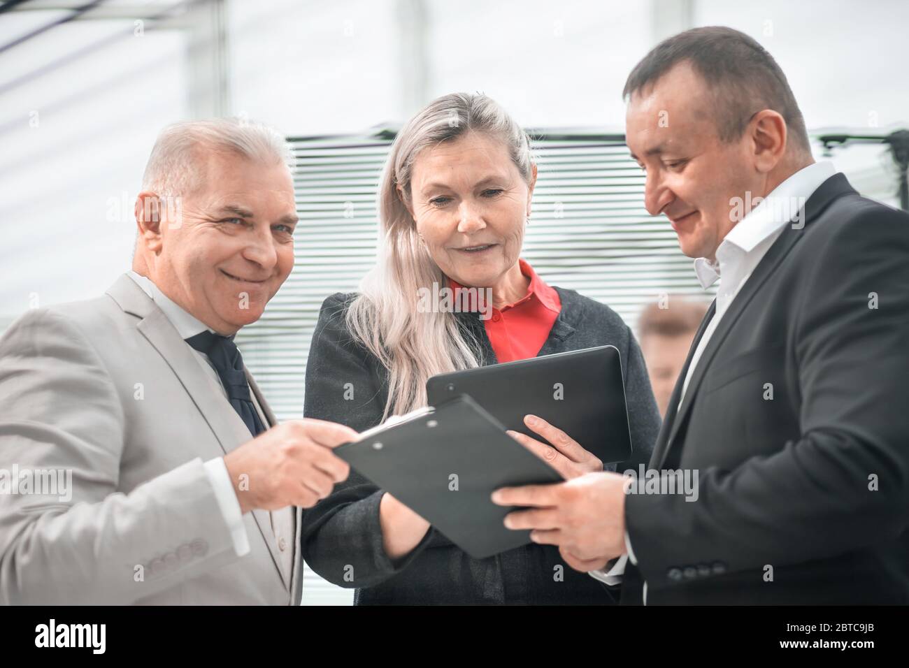 project Manager discussing working documents with colleagues Stock ...