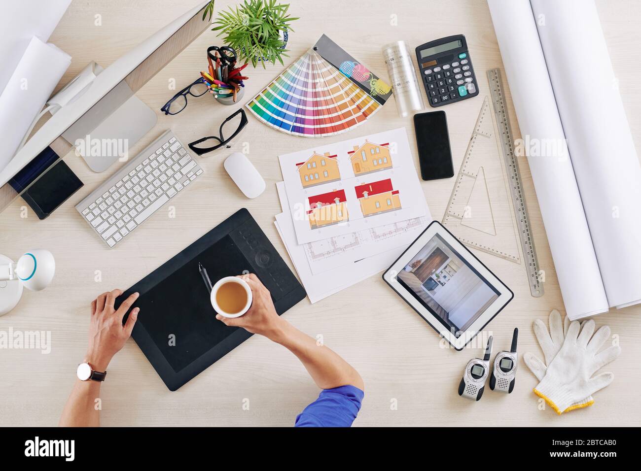 Interior designer drinking cup of coffee when working on project of ...
