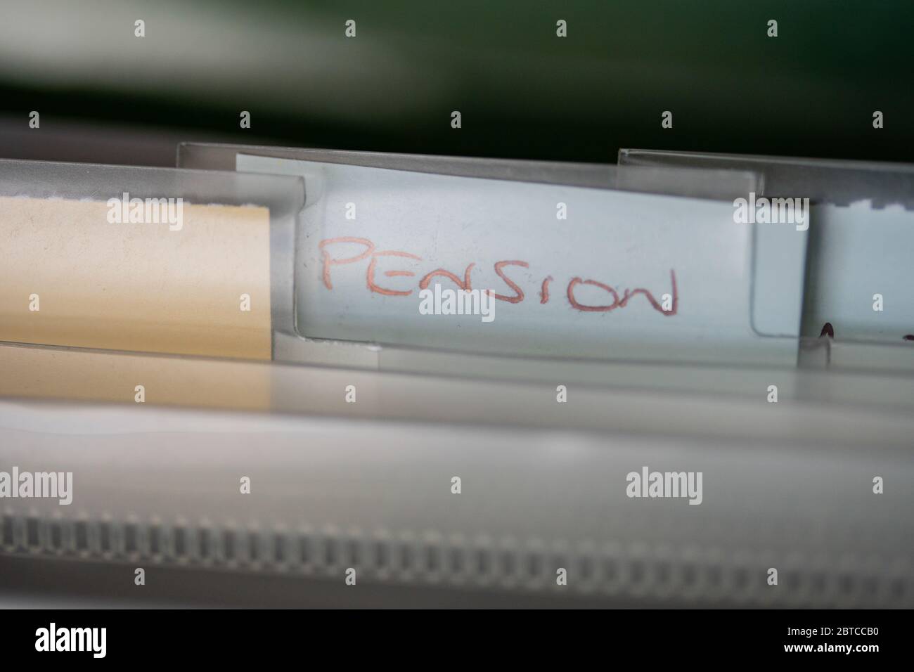 A label within a file organiser with the wording Pension.Normally a place where household bills and other important documents are kept. Stock Photo