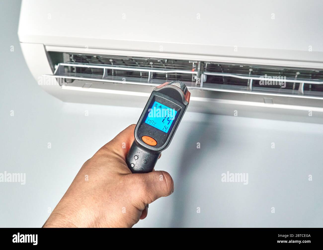 https://c8.alamy.com/comp/2BTCEGA/engineer-checking-temperature-by-infrared-thermometer-inside-of-air-conditioner-checking-temperature-inside-of-an-air-conditioner-helps-to-troublesho-2BTCEGA.jpg