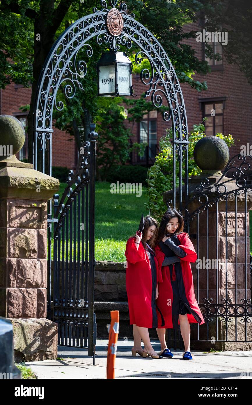 Students in graduation caps and gowns at Rutgers University's Old Queens ampus gates; amid commencement ceremony cancellations resulting from the COV Stock Photo