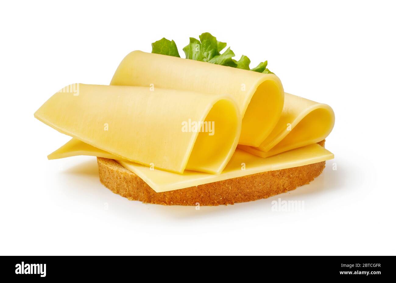 Cheese slices with salad leaf on piece of bread. Sandwich isolated on white background. Stock Photo