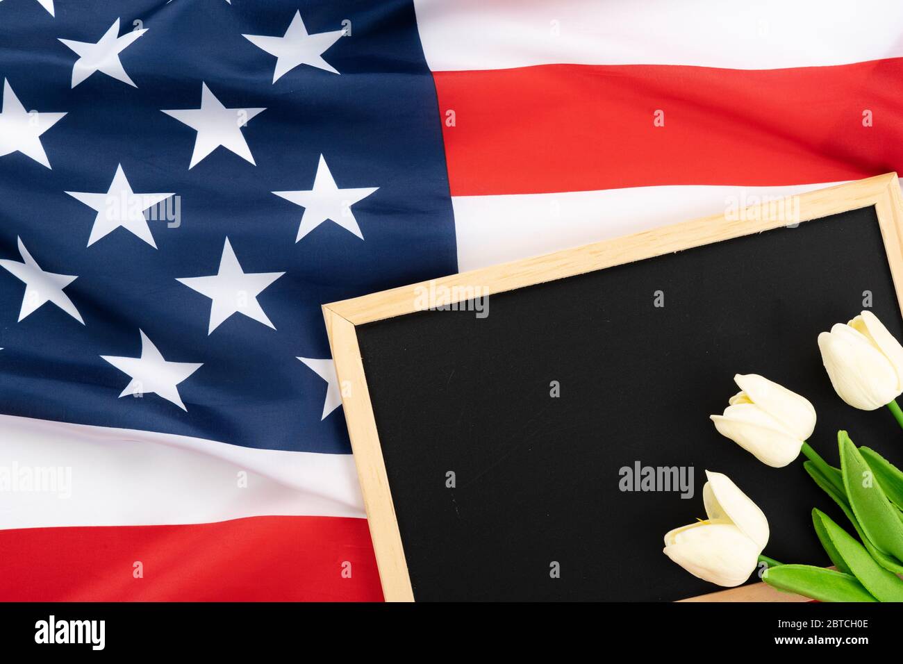 US American flag with blackboard and tulip on white background. For USA Memorial day, Presidents day, Veterans day, Labor day, Independence or 4th of Stock Photo
