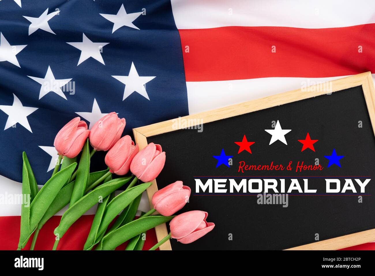US American flag with blackboard and tulip on white background. For USA Memorial day. Top view with memorial day text. Stock Photo