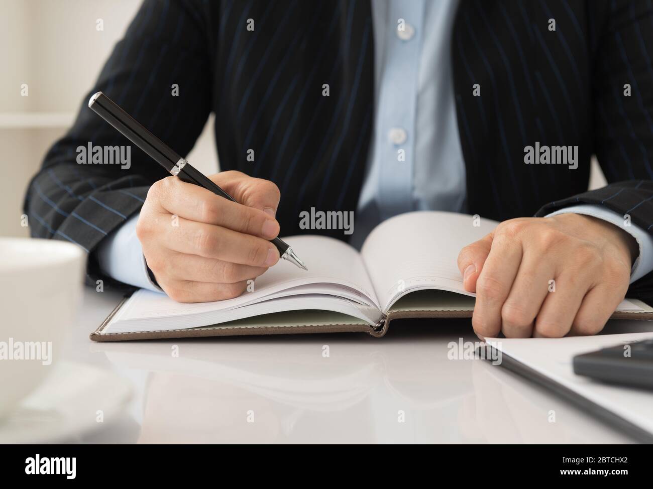 manager take notes personal organizer or planner on notebooks Stock