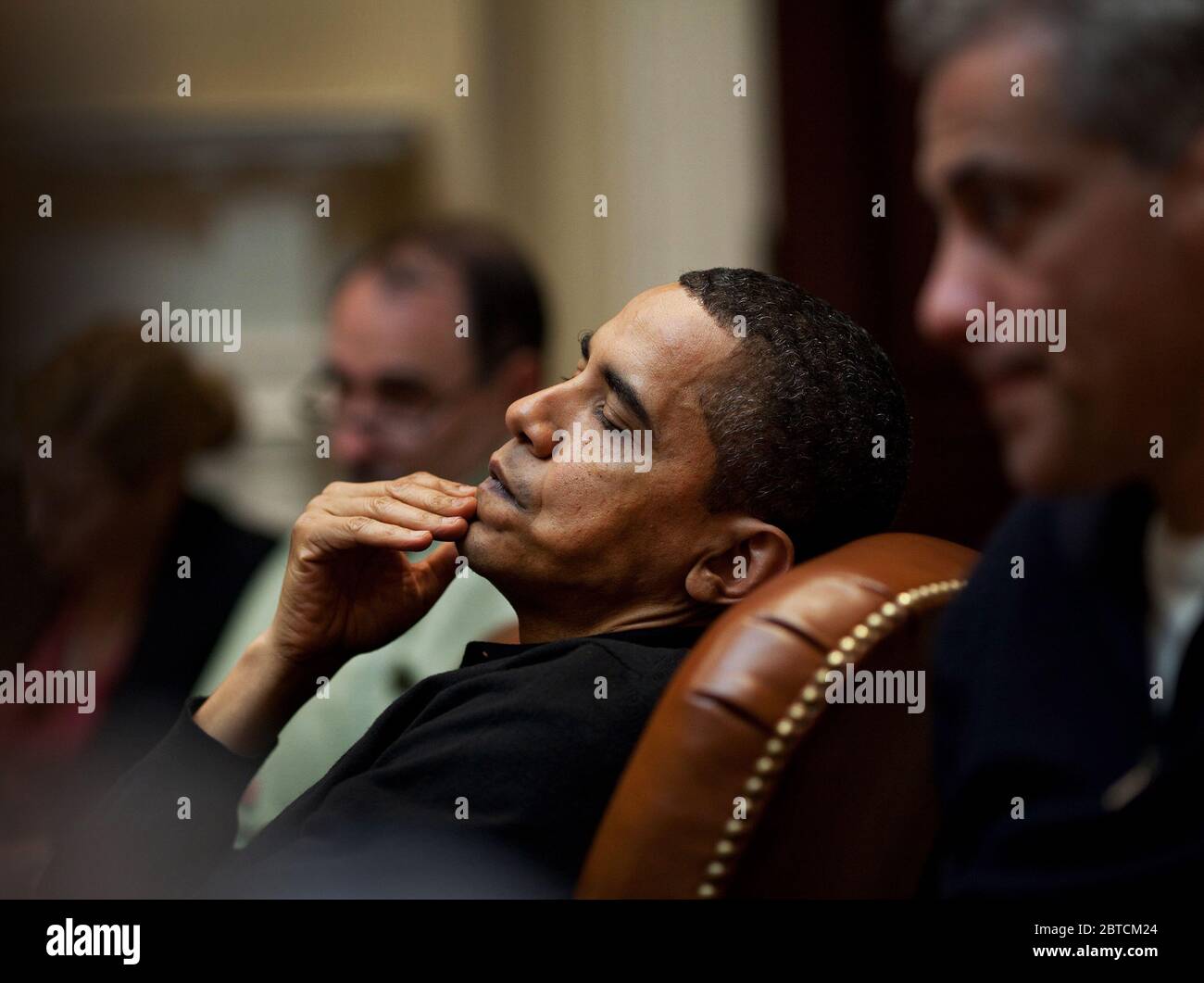President Obama reflects during an economic meeting with advisors in the Roosevelt Room. He is seated between Senior Advisor David Axelrod and Chief of Staff Rahm Emanuel , right. 3/15/09. Stock Photo