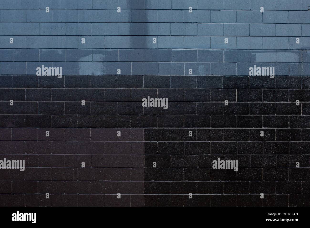 Dark painted brick wall, grunge background Stock Photo