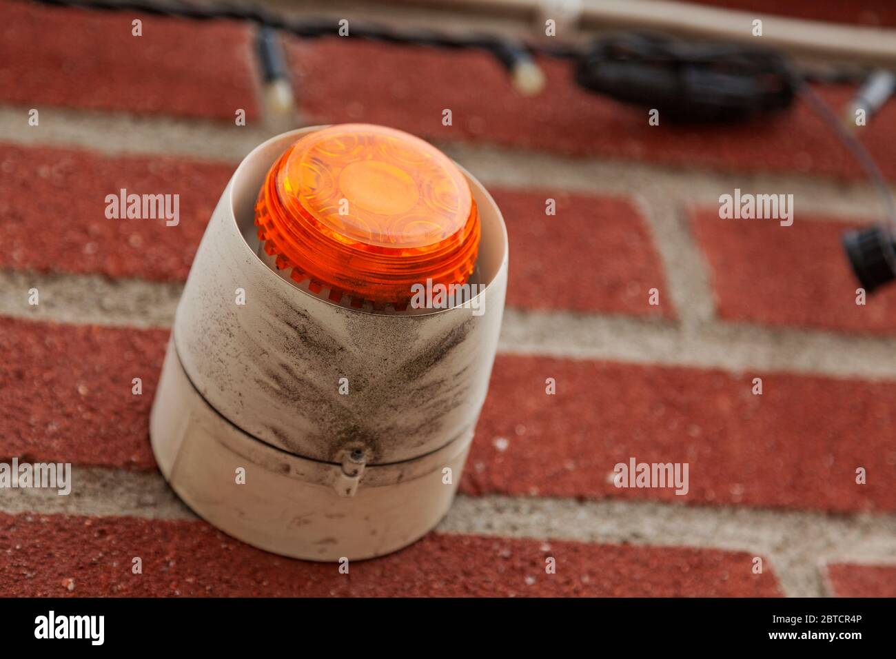 an orange lamp for alarm outside a store Stock Photo Alamy