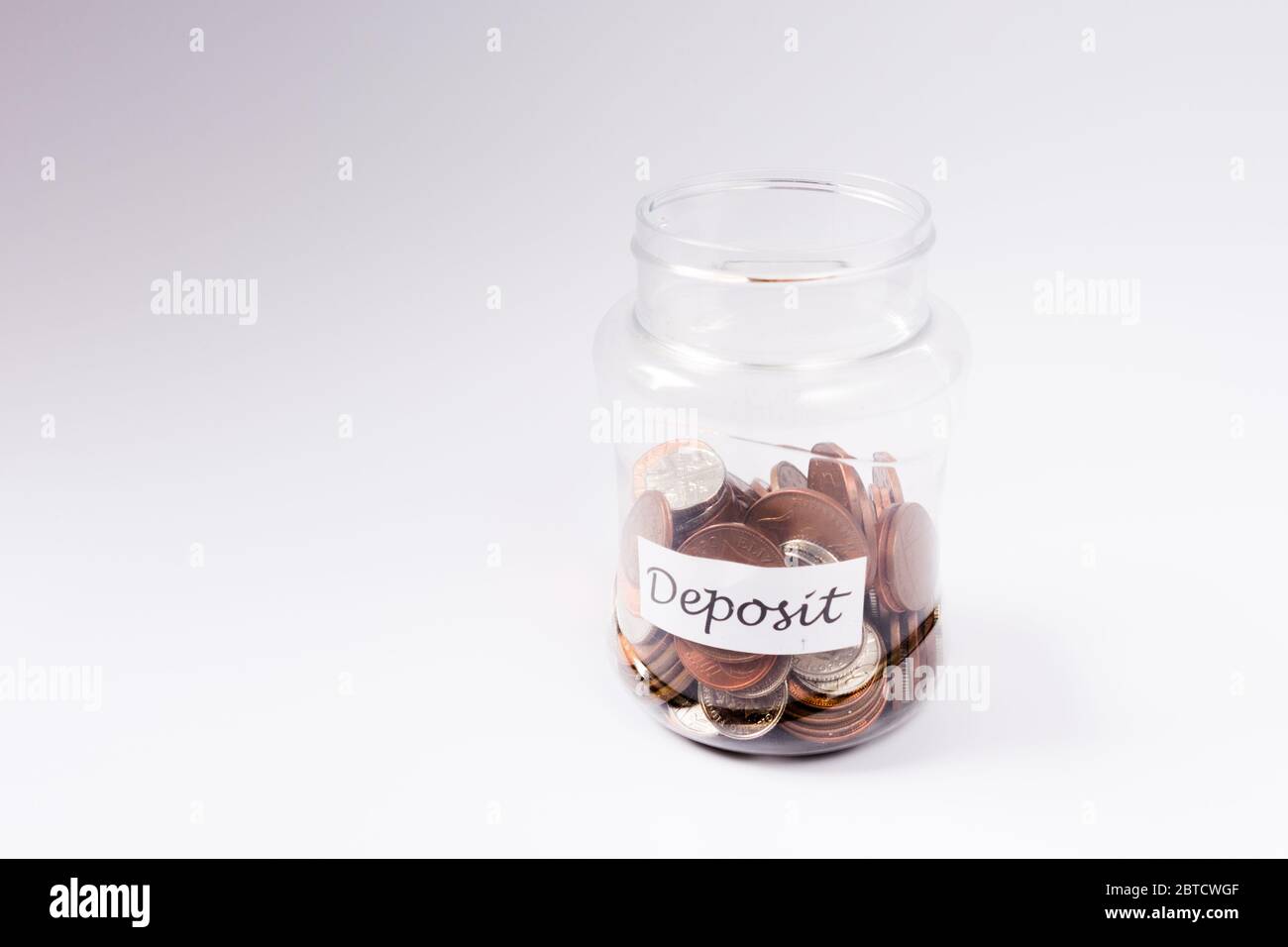 Deposit saving coin jar concept symbolising a saving for car, home, education etc. Stock Photo