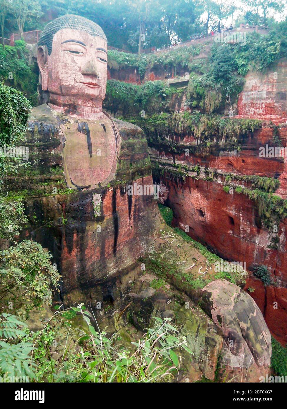 The Leshan Giant Buddha is a 71-metre tall stone statue carved out of a cliff face of cretaceous red bed sandstones in Leshan, Sichuan, China. Stock Photo