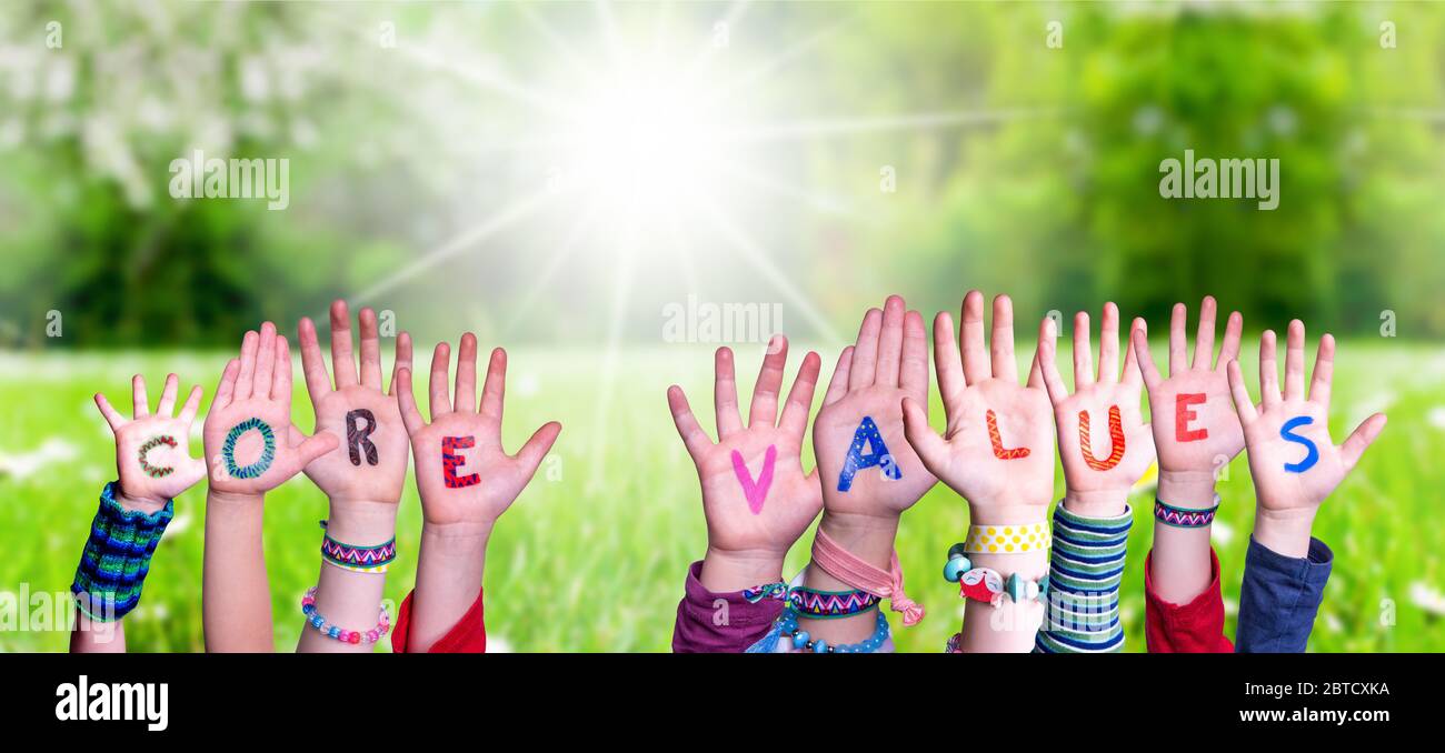 Children Hands Building Word Core Values, Grass Meadow Stock Photo