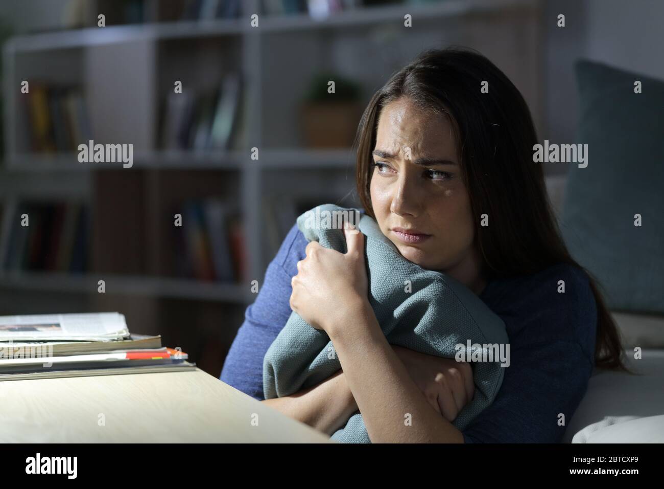 Frightened woman alone dark room hires stock photography and images