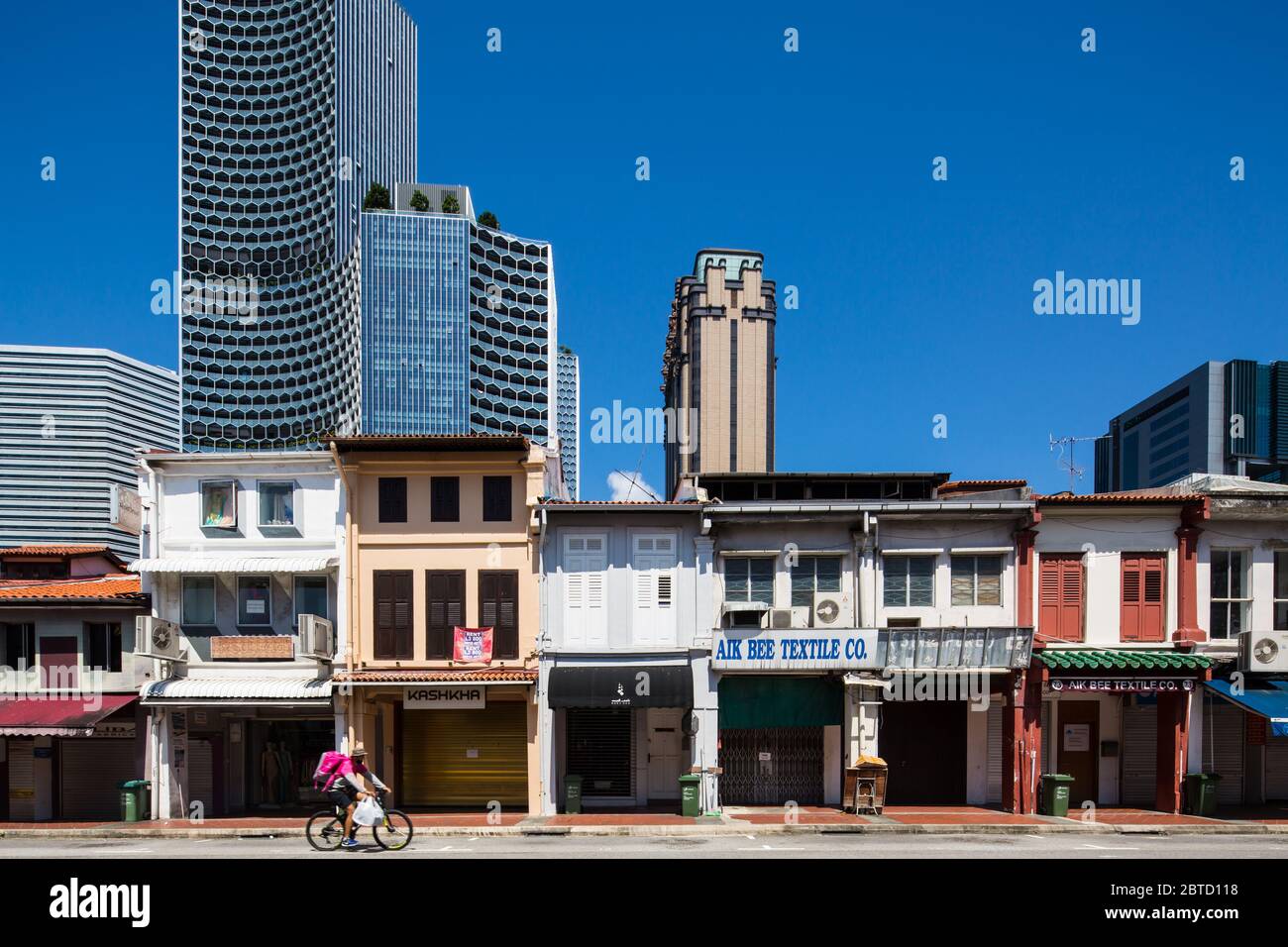 Essential worker like food delivery rider delivers food despite the tough time caused by Covid-19 pandemic, Singapore. Stock Photo