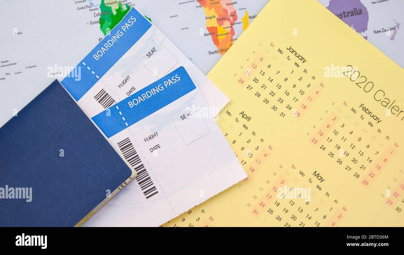passport, boarding pass over map. travel concept. on calendar with pins Stock Photo