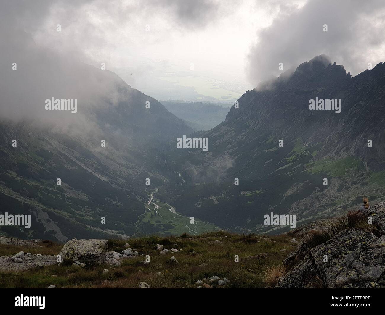 Clouds over the mountains on the peak of the mountain Stock Photo - Alamy
