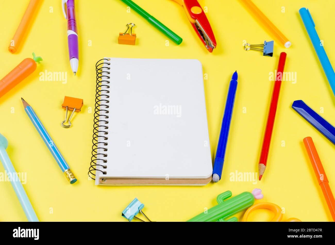 School Supplies And Coloring Pens Flat Lay On Yellow Background