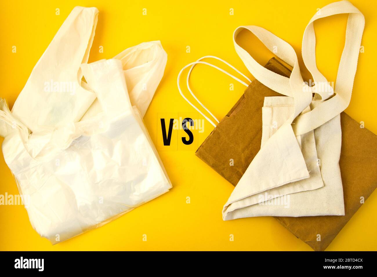 Clear disposable plastic bag on yellow background vs eco tote bags