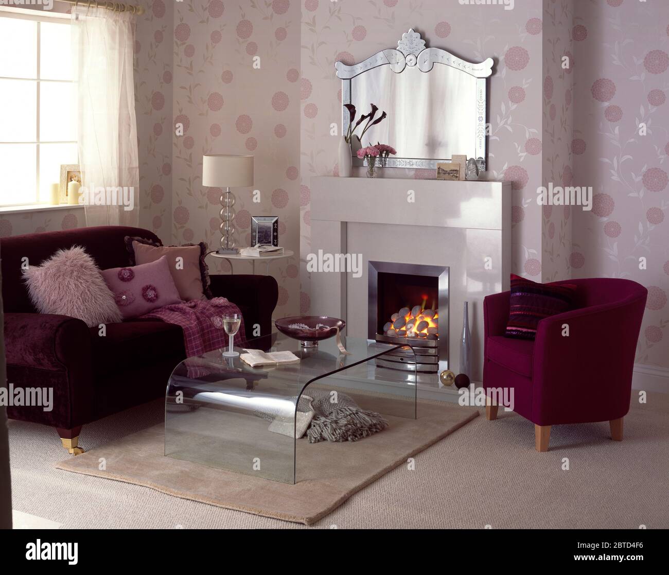 Purple velvet sofa and chair in living room with acrylic coffee table Stock Photo