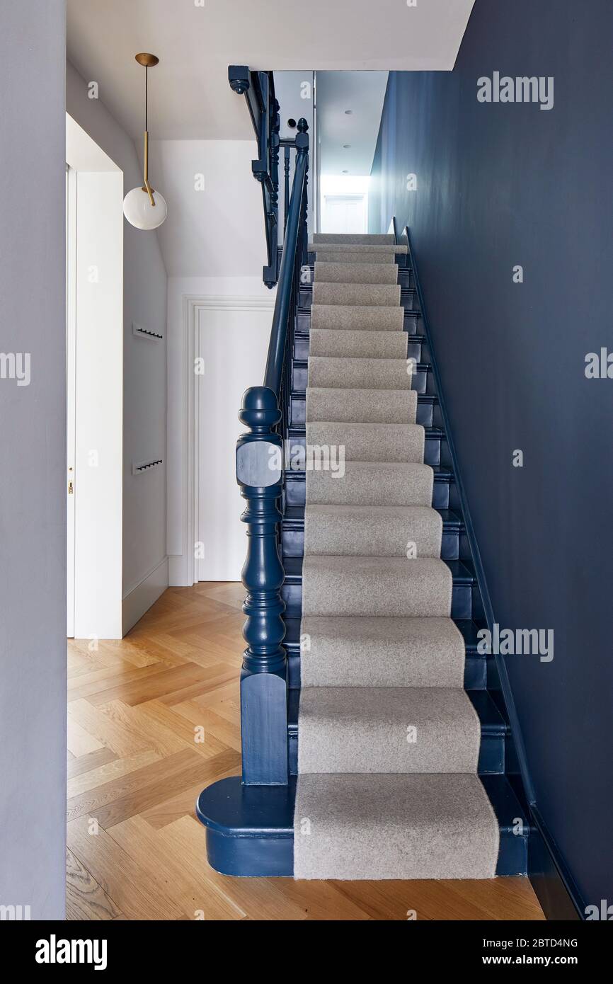 Blue staircase with ribbed wooden slat design. Long House, London, United Kingdom. Architect: R2 Studio , 2018. Stock Photo