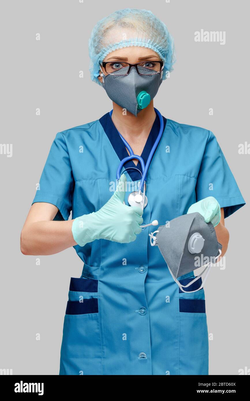 female doctor with stethoscope wearing protective mask and latex gloves ...