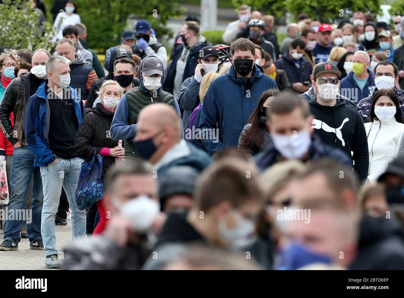Minsk, Belarus. 24th May, 2020. People in face masks queue to add their signatures in support of presidential candidate Svetlana Tikhanovskaya (not pictured) during a rally outside Komarovsky Market organised by activists to collect signatures in support of 15 presidential hopefuls. The campaign in support of potential presidential candidates started on 21 May. Belarus is to hold a presidential election on 9 August 2020. Credit: Natalia Fedosenko/TASS/Alamy Live News Stock Photo