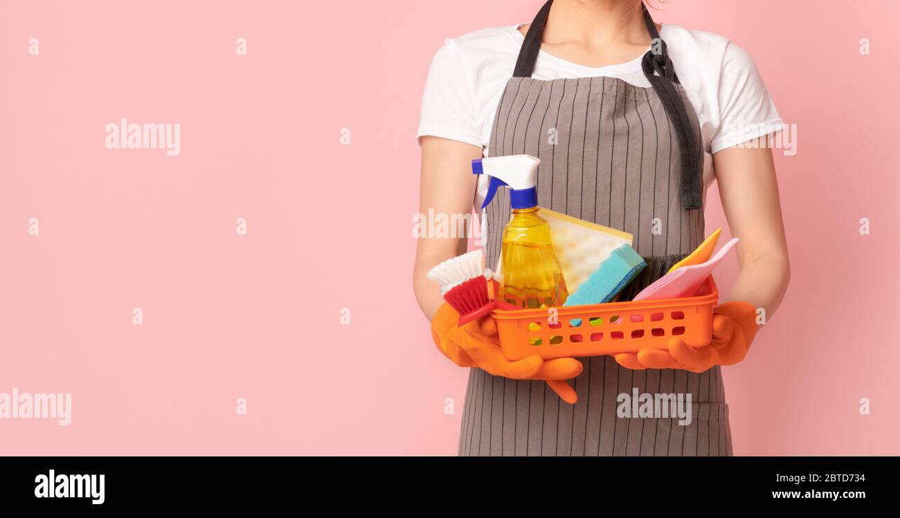 Professional Cleaning Services. Basket With Household Supplies In Hands Of Unrecognizable Housemaid Stock Photo