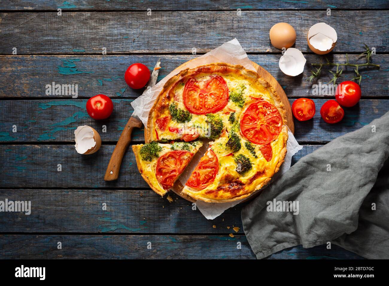 Overhead view of Veggies quiche on rustic table Stock Photo