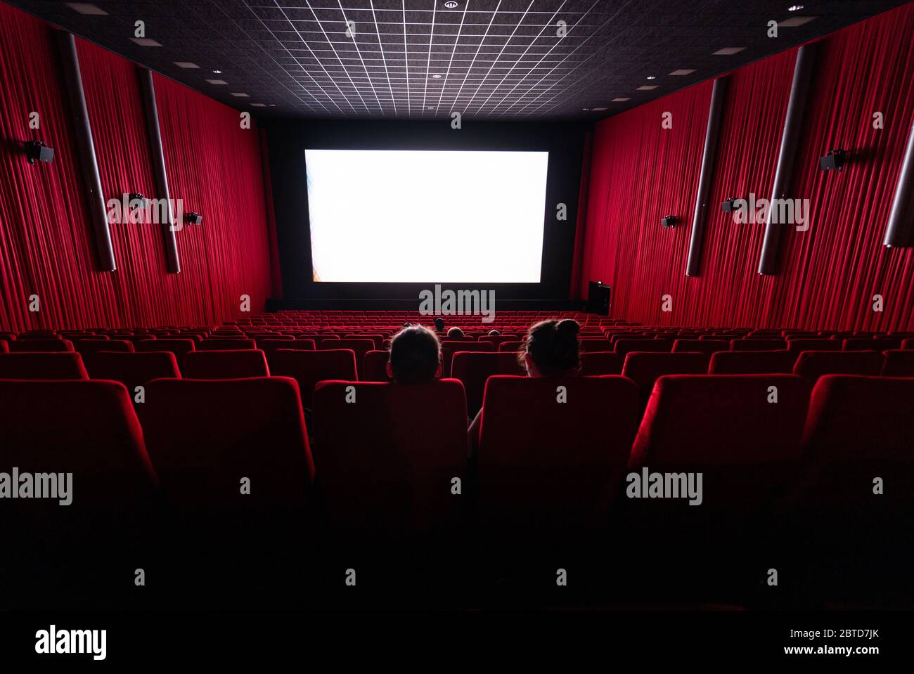 Dresden, Germany. 22nd May, 2020. Few visitors sit in a hall in the cinema Ufa-Kristallpalast in the Innnenstadt and look at the screen. As the first big cinema in the city the Ufa-Palast was allowed to reopen after the Corona-Lockdown. (to dpa 'With popcorn, without mask: How can a visit to the cinema look like now?') Credit: Robert Michael/dpa-Zentralbild/dpa/Alamy Live News Stock Photo