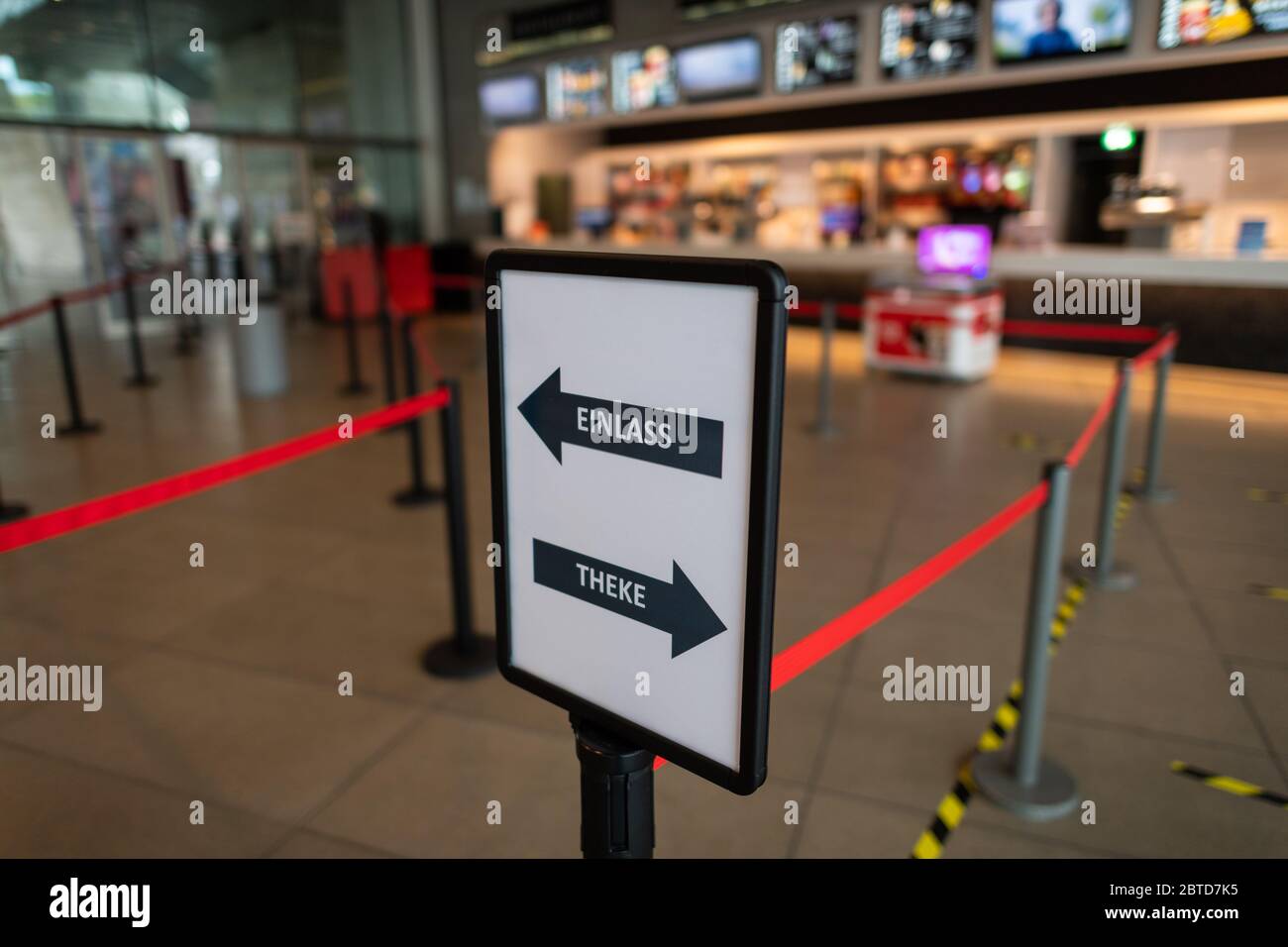 Dresden, Germany. 22nd May, 2020. A sign with running directions and barrier tapes are set up foyer in the cinema Ufa-Kristallpalast in the Innnenstadt. As the first big cinema in the city, the Ufa-Palast was allowed to reopen after the Corona-Lockdown. (to dpa 'With popcorn, without mask: How can a visit to the cinema look like now?') Credit: Robert Michael/dpa-Zentralbild/dpa/Alamy Live News Stock Photo