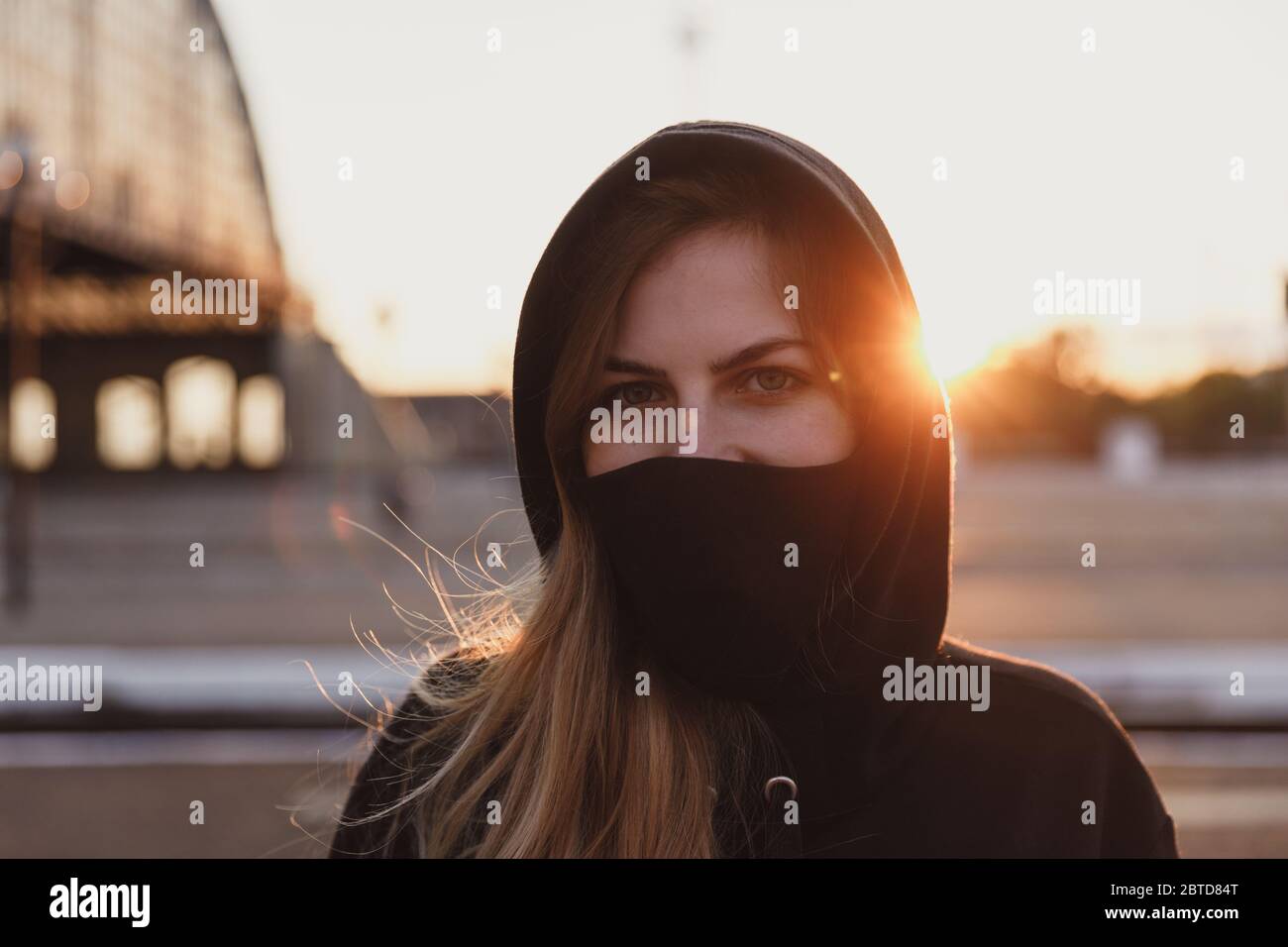 Close up Portrait of Girl in black medical mask stay in train station ...