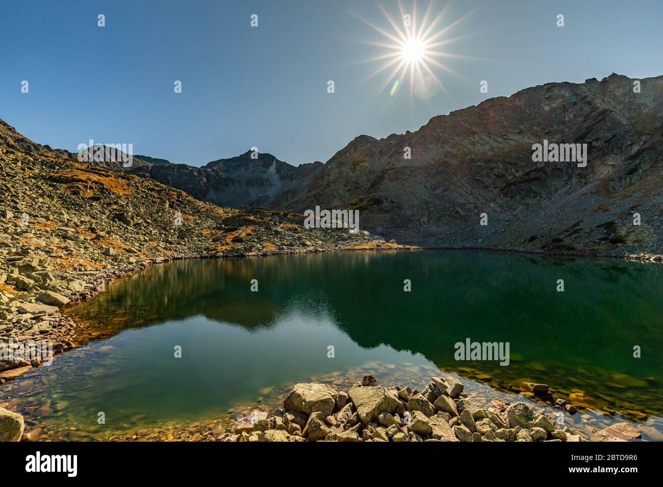 Mountain lake with bright sunshine near Musala, Rila region in Bulgaria Stock Photo