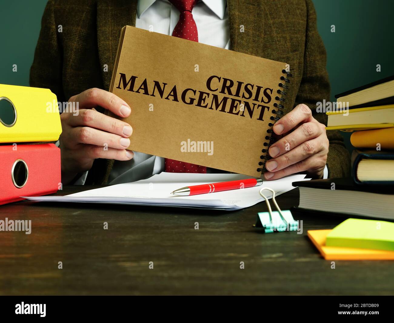 Businessman holds Crisis Management plan. Stock Photo
